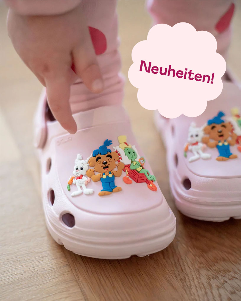 Kinderschuh mit Klettverschluss und 'Neuheiten!' in lila Blase.