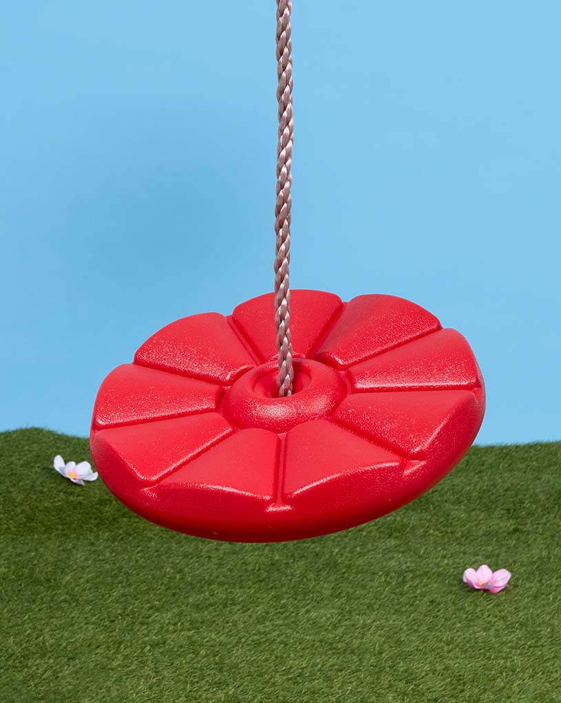 Ein Kind schaukelt draußen bei Sonnenschein.